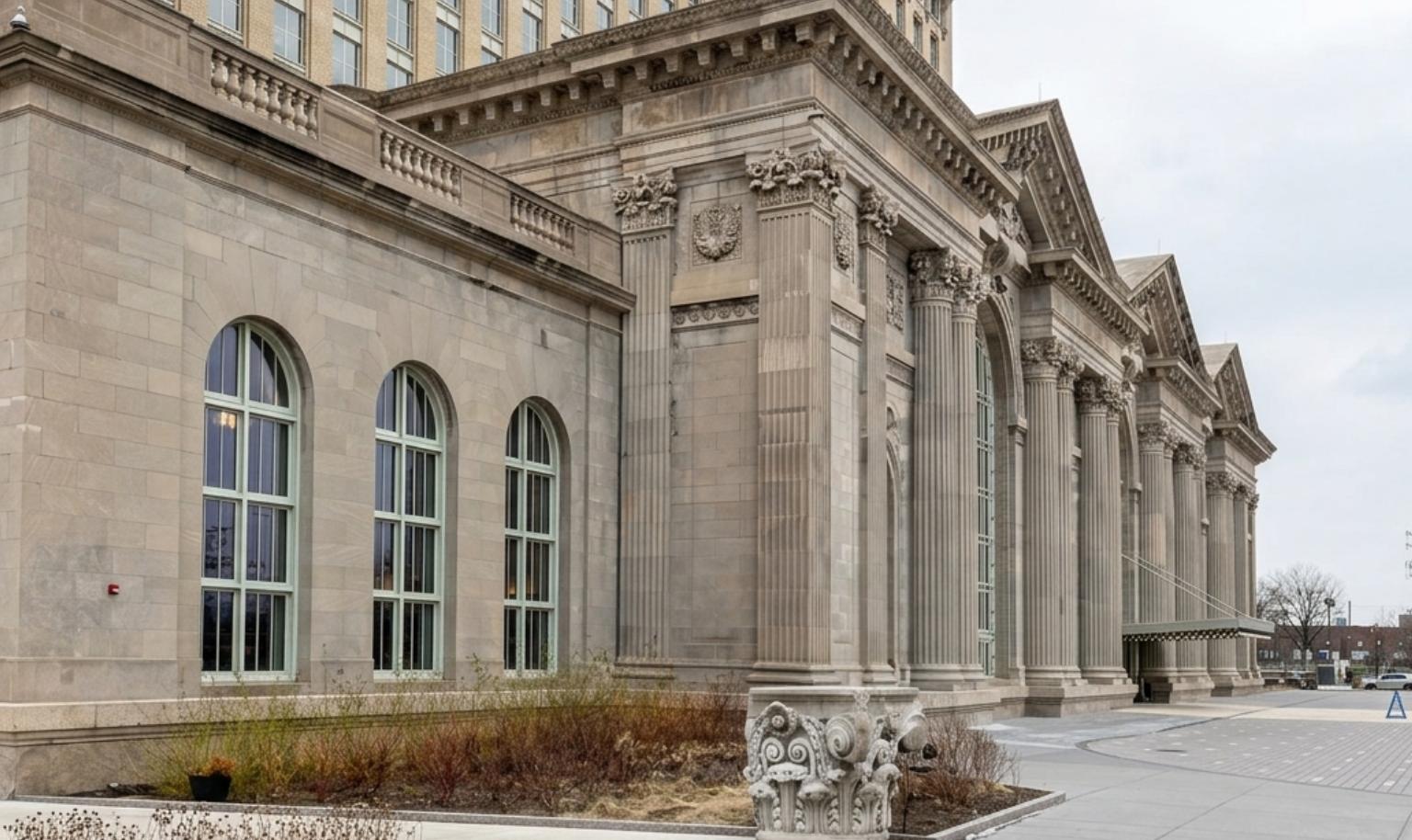 Michigan Central Station exterior in Detroit showing restored front entrance and columns from a side perspective